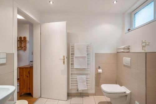 a white bathroom with a toilet and a sink at Ferienwohnung Gaby Lehmann in Hornberg