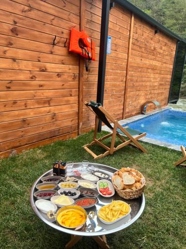 a tray of food on a table next to a pool at VALLEY SUiT OTEL in Rize