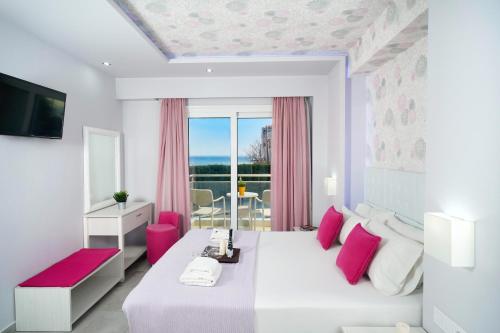 a white bedroom with a large bed with pink accents at Lafeyra Hotel in Limenaria