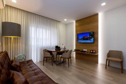 a living room with a couch and a table at The Office Guest in Guimarães