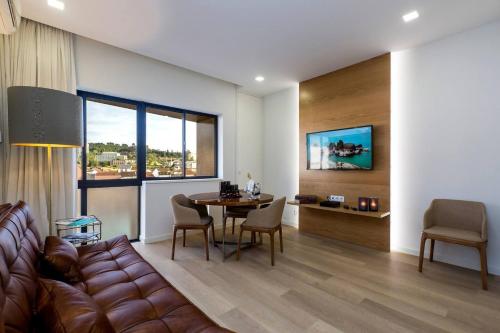 a living room with a couch and a table at The Office Guest in Guimarães