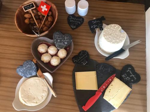 a table topped with different types of food and desserts at Spacious House with Mountain View in Haut-Intyamon in Les Sciernes d'Albeuve