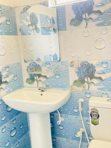 a bathroom with a sink and a toilet at Sea Side Bay House in Weligama