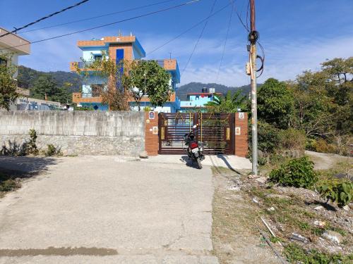 a motorcycle parked on the side of a road at Shanti Rental And Dormitory in Kāthgodām