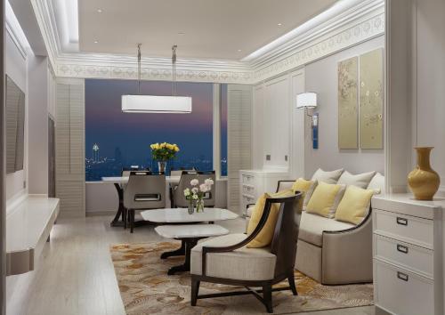 a living room with a couch and a table at Grande Centre Point Lumphini Bangkok in Bangkok