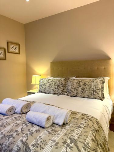 a bedroom with a bed with towels on it at The Old Hunting Lodge at The Talbot Inn in Tenbury