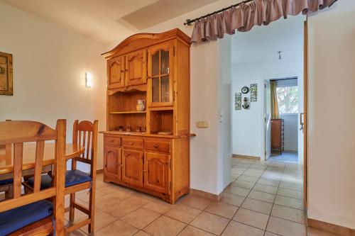 a dining room with a wooden cabinet and a table at Clip C-3 - Llafranc in Llafranc
