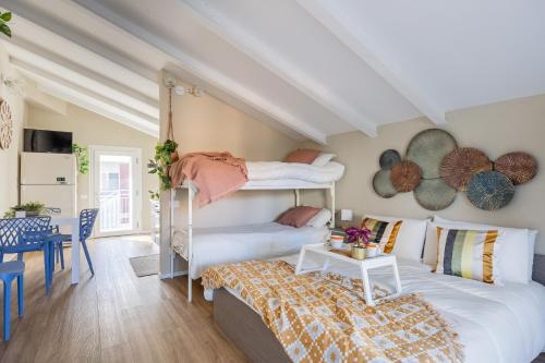 a bedroom with two bunk beds and a table at Via Giunone 1A Bilo in Cervia