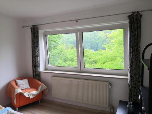 a window in a room with a chair and a radiator at Sweet Home in Egloffstein
