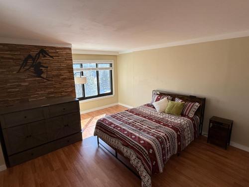 a bedroom with a bed and a brick wall at Unique 2 Bed, 2 Bath with In & Out Night Skiing in Snowshoe