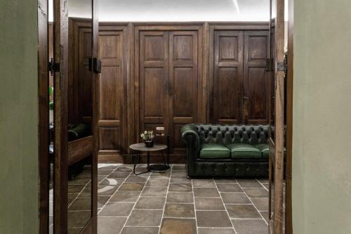 ボルツァーノにあるGoldenstern Townhouseの緑のソファとテーブルが備わるお部屋