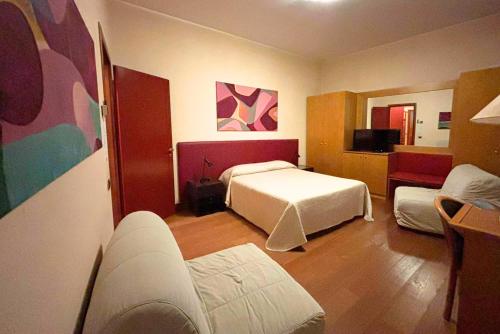 a hotel room with a bed and a couch at Residence La Fenice in Padova