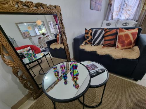 a living room with a table and a mirror at Condo for Rent Cheer Residences in Marilao