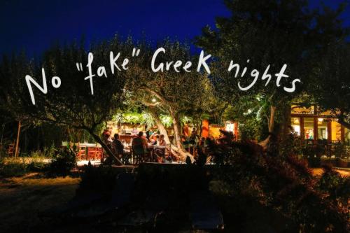 a sign that says no take creek nights at night at Hotel Votsala in Pyrgi Thermis