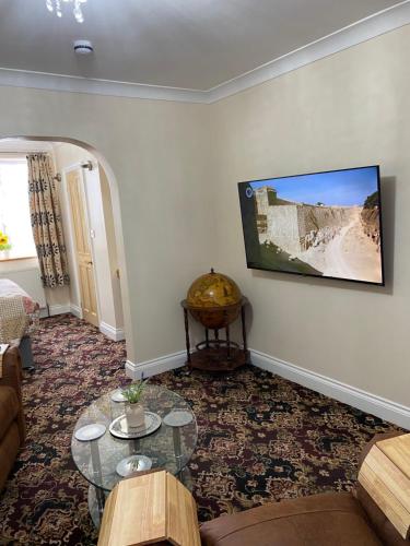a living room with a couch and a table at Barons Court in Great Yarmouth