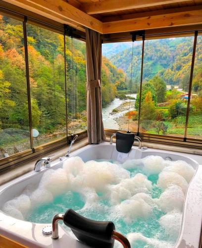 a bath tub with a view of a mountain at VALLEY SUiT OTEL in Rize