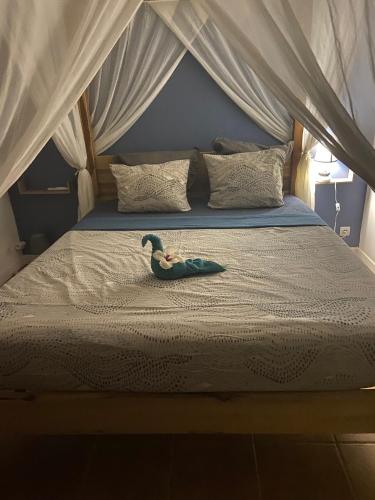 a toy duck sitting on top of a bed at Colibri Villa Sainte Luce in Sainte-Luce