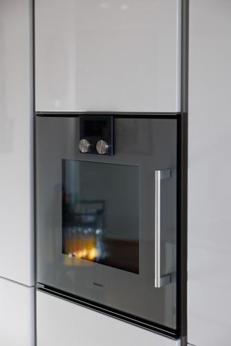 a refrigerator with a fire in the oven at Luxury Apartment Villach City in Villach