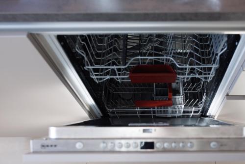 a microwave oven with a dish rack in it at Luxury Apartment Villach City in Villach