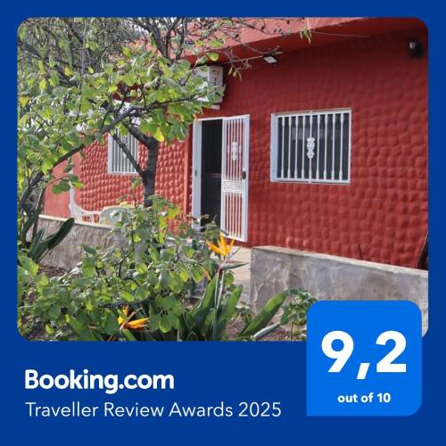 a red house with a sign that says travel review awards at Casa rural Finca Don Amado, San Mateo in Las Palmas de Gran Canaria