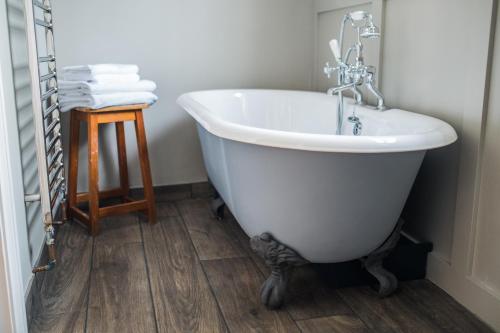a white bath tub with a faucet in a bathroom at The Redan Inn in Chilcompton