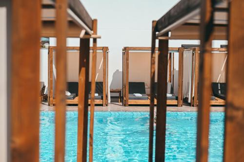 a view of a swimming pool through a fence at Bianco Hotel in Ksamil