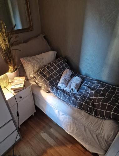 a bed with two pillows on it in a room at Sjarmerende leilighet i hjerte av Tønsberg by in Tønsberg