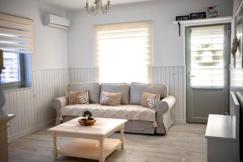 a living room with a couch and a coffee table at FLH - Algo Bueno in Suceava