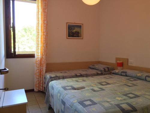 a room with two beds and a window at Fenice in Bibione