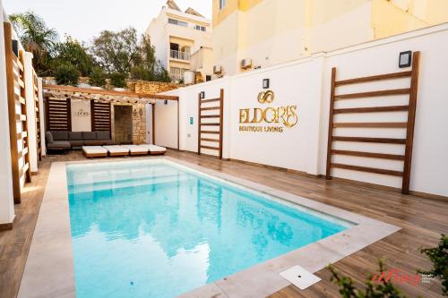 a swimming pool in front of a building at El Doris Boutique Living St Julian's in St. Julianʼs