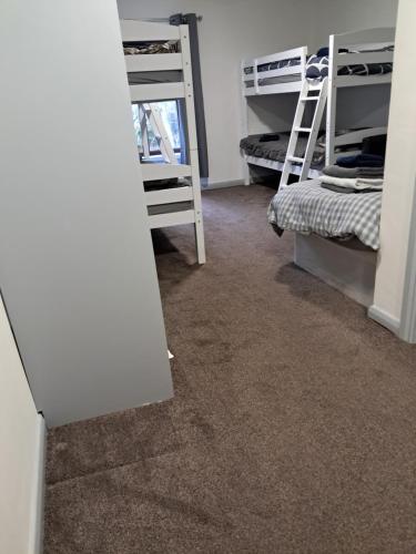 a room with two bunk beds and a carpet at Black Bull in Wylam