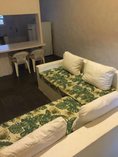 a bed with two pillows on it in a room at Vila Giulia in Maresias
