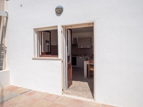 an open door to a kitchen in a white house at Villa Cordella 3 in Patù