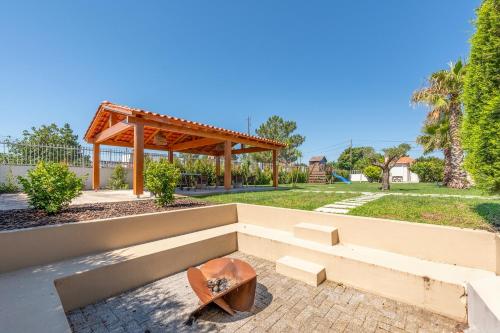 a patio with a bench and a gazebo at Magalhães Village by LovelyStay in Santo António da Charneca