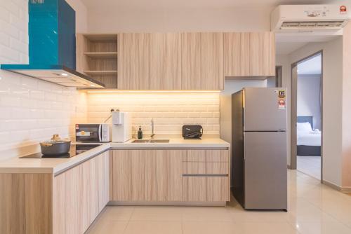 a kitchen with a refrigerator and a sink at Iconic Regency by Stellar ALV in Bayan Lepas