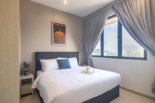 a bedroom with a bed with a teddy bear on it at Iconic Regency by Stellar ALV in Bayan Lepas
