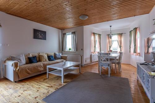 a living room with a couch and a table at Chata Bart in Krásný Les