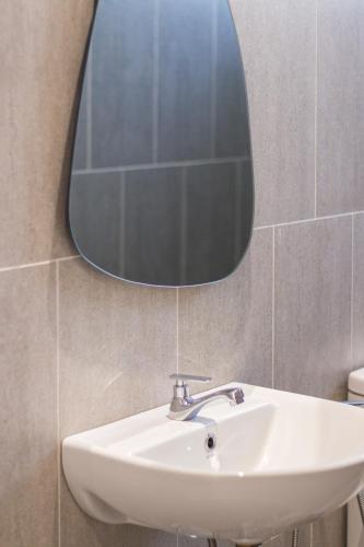 a bathroom with a sink and a mirror on the wall at Iconic Regency by Stellar ALV in Bayan Lepas