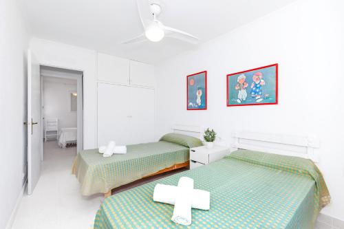 a room with two beds with crosses on them at Casa Joana Cap d'Artrutx in Cala'n Bosch