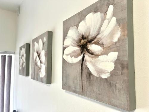 a painting of a white flower on a wall at Lovely Double Room with En Suite and separate private entrance in Kingshurst
