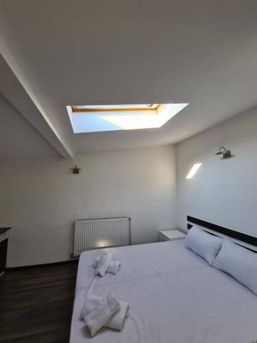 a bedroom with a bed with two towels on it at Duplex Family Apartment in Skopje