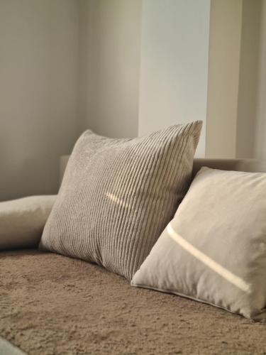 a pillow sitting on top of a bed at Duplex Family Apartment in Skopje