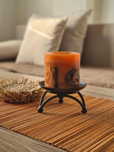 an orange coffee cup on a stand on a table at Duplex Family Apartment in Skopje