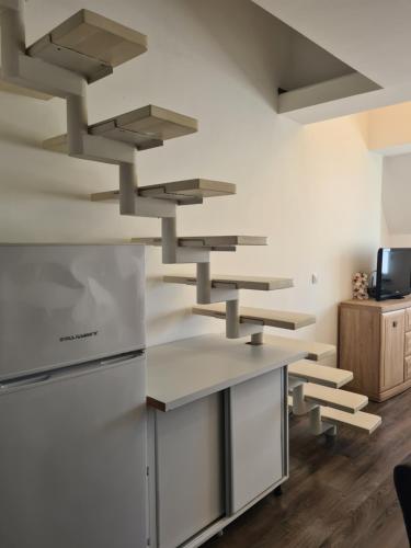 a kitchen with wooden floors and stainless steel appliances at Duplex Family Apartment in Skopje