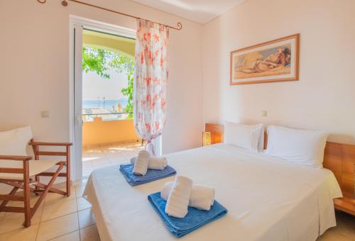 a bedroom with a bed with towels on it at Barbati Angela's Garden Sea View in Barbati