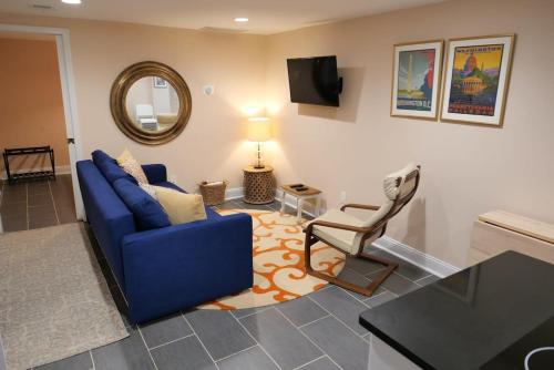 a living room with a blue couch and a chair at Rock Creek Park Residence in Washington, D.C.