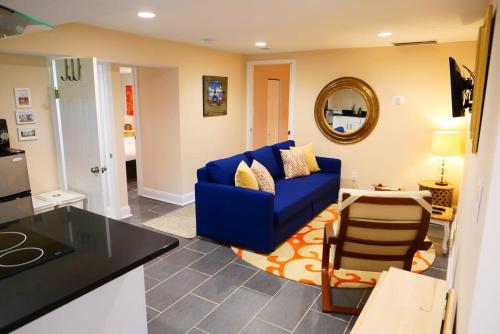 a living room with a blue couch and a table at Rock Creek Park Residence in Washington, D.C.