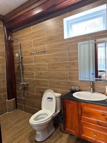 a bathroom with a toilet and a sink at Mộc Lan resort in Phú Quốc