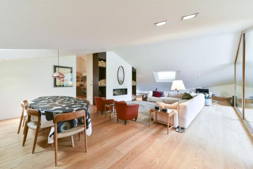 a living room with a table and a couch at Chesa Arpiglia - Zuoz in Zuoz
