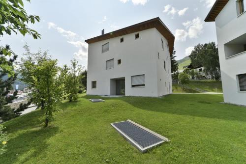 a house with a solar panel in the yard at Chesa Arpiglia - Zuoz in Zuoz